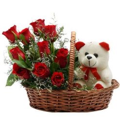 Red roses with cute teddy in basket