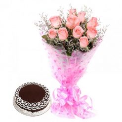 Chocolate cake accompanied by a beautiful bunch of pink roses, perfect for a memorable celebration or special occasion.