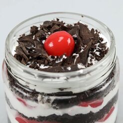 Two jars of decadent Black Forest cake with creamy layers, perfect for indulging in dessert bliss.