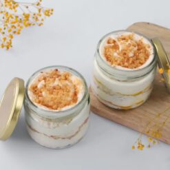 Set of six glass jars filled with layers of indulgent butterscotch cake, perfect for satisfying your sweet cravings.