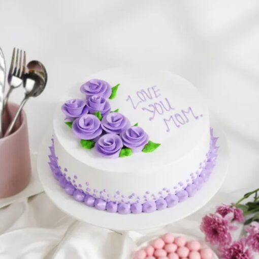 A delicious cake with lavender accents and "Mother's Day" written on it, perfect for celebrating mom's special day.
