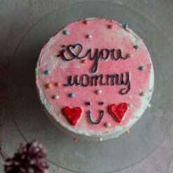 Love You Mommy Cake - A heart-shaped cake with colorful frosting and a 'Love You Mommy' message written in icing.