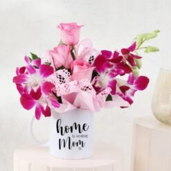 Floral Mug Surprise for Mom - A beautiful arrangement of roses and orchids to celebrate Mother's Day.
