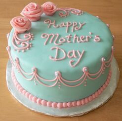 A blue cake adorned with pink rose petals, a delightful treat for Mother's Day celebrations.