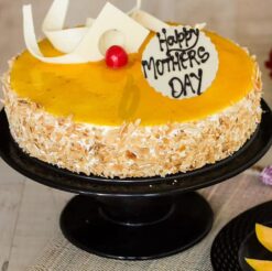 A tantalizing mango cake, perfect for tempting Mom's taste buds on Mother's Day with its sweet tropical flavor.