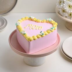 A delightful pink heart-shaped cake, expressing sweet affection for Mom on Mother's Day.