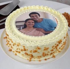 A butterscotch cake adorned with a personalized photo, perfect for celebrating Mom on Mother's Day with love and sweetness