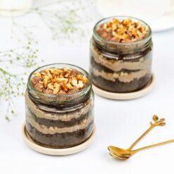 Four jars of delicious choco walnut cakes, perfect for enjoying rich flavors and nutty goodness.