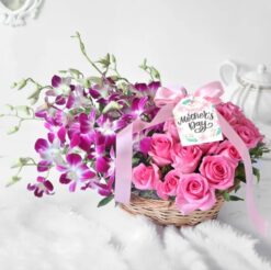 Purple orchids and pink roses arranged in a basket for Mother's Day gift
