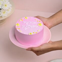 A regal pink cake adorned with elegant decorations, fit for the queen of your heart, perfect for celebrating Mom.