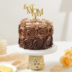 A decadent chocolate cake adorned with rosy decorations, perfect for celebrating Mom's sweetness on Mother's Day.