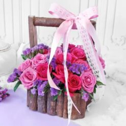 A wooden basket filled with a variety of colorful roses, a charming floral arrangement perfect for rustic-chic decor or gifting.