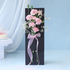 A stylish slate container filled with a sophisticated arrangement of classy carnations, perfect for adding elegance to any space.