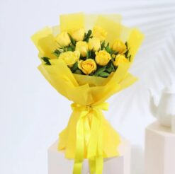 A bouquet of ten yellow roses wrapped in tissue paper, perfect for gifting and brightening someone's day.