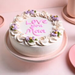 A decadent vanilla cake adorned with affectionate details, perfect for celebrating Mother's Day with love and sweetness.