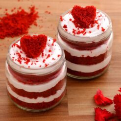 Four heart-shaped jars filled with delicious red velvet cake, perfect for indulging in rich, velvety sweetness.
