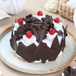 Midnight Cherry Forest Cake: Rich chocolate layers adorned with cherries, perfect for indulging in a decadent dessert experience.