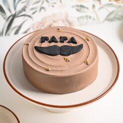 Decadent chocolate cake with frosting, designed as a special treat for Papa's enjoyment.
