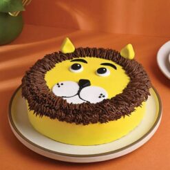 Cute lion cream cake with whimsical cream decorations, ideal for birthdays and celebrations for animal lovers.
