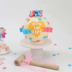 Gender reveal pinata cake with colorful decorations, ideal for celebrating and revealing a baby's gender with a surprise inside.