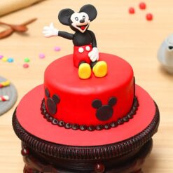 Mickey Mouse round fondant cake with colorful decorations, ideal for birthdays and Disney-themed celebrations.