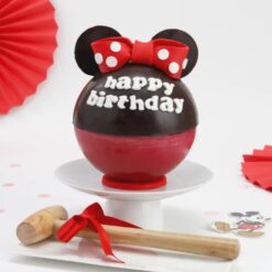 Minnie Mouse theme pinata cake with colorful decorations and surprises inside, ideal for birthdays and celebrations.