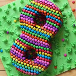 Number eight gems cake adorned with colorful gem decorations, ideal for birthdays and celebrations.