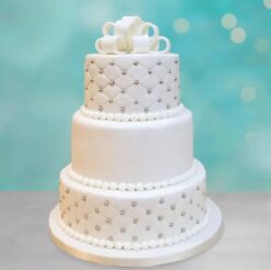 Exquisite silver pearl three-tier cake with intricate decorations, perfect for weddings and celebrations.