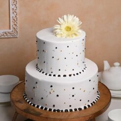 Elegant two-tier wedding cake adorned with intricate floral decorations, crafted to perfection for your unforgettable special day